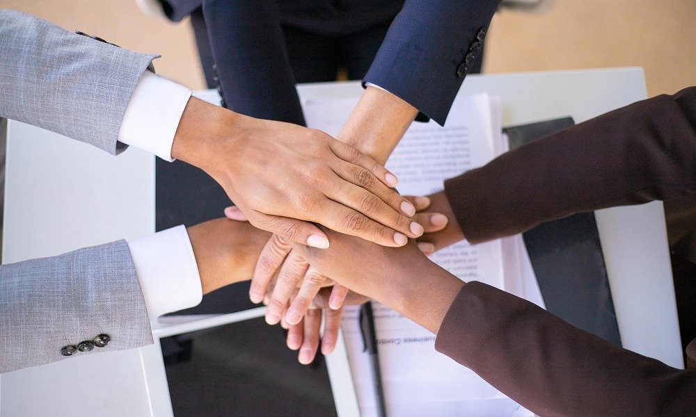 hands piled onto one another